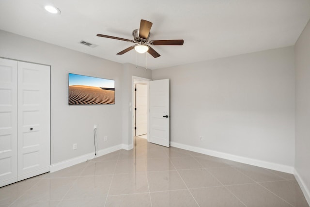 unfurnished bedroom featuring a closet, ceiling fan, and light tile patterned floors