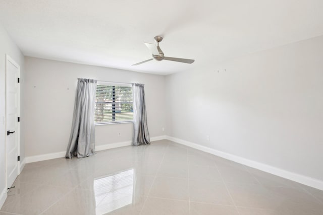 tiled empty room with ceiling fan