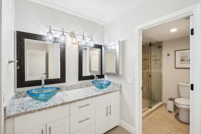 bathroom featuring tile patterned flooring, an enclosed shower, toilet, and vanity