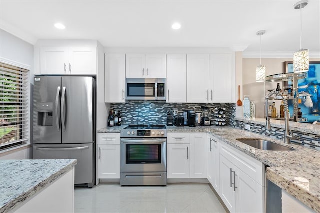 kitchen with appliances with stainless steel finishes, crown molding, decorative backsplash, and white cabinetry