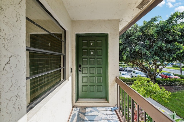 entrance to property featuring a balcony