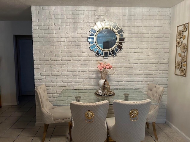 dining space with tile patterned flooring and a textured ceiling