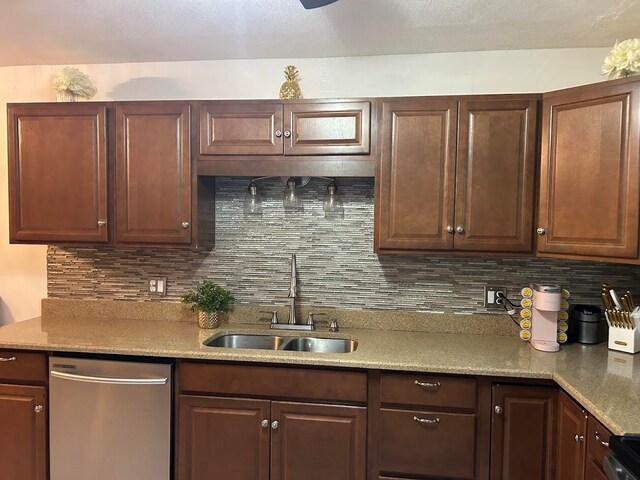 kitchen featuring appliances with stainless steel finishes, tasteful backsplash, sink, and light stone countertops