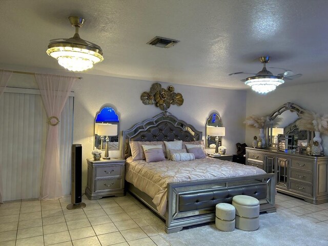 tiled bedroom featuring a textured ceiling and ceiling fan