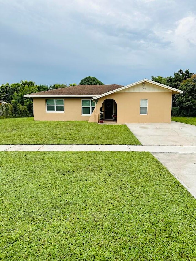 single story home with a front lawn