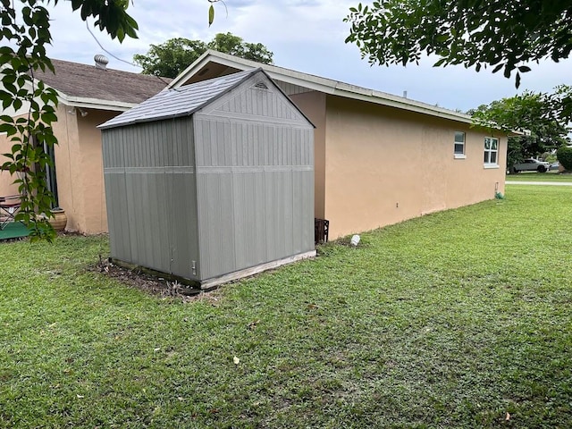 view of outbuilding with a lawn