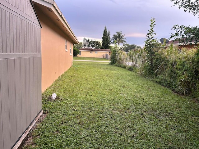 view of yard at dusk