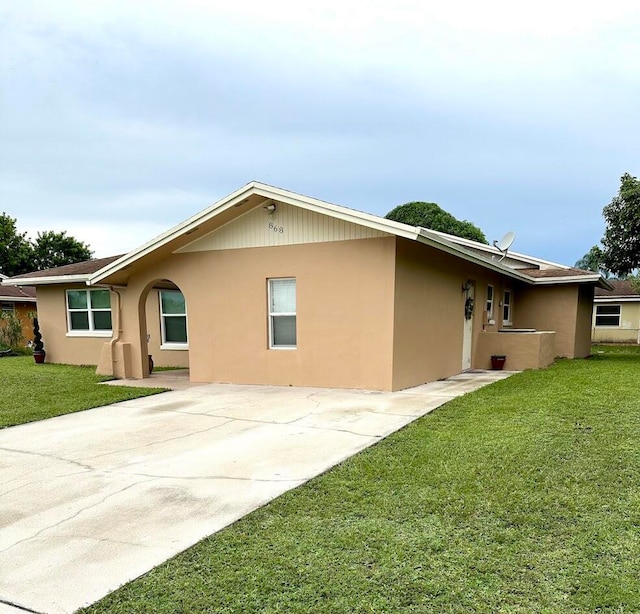 ranch-style house featuring a patio area and a front lawn