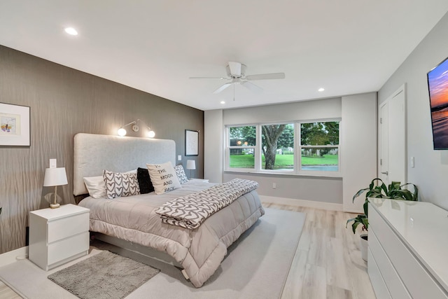 bedroom featuring ceiling fan and light hardwood / wood-style flooring