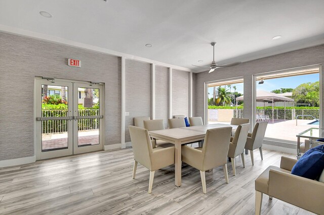 dining area with light wood-type flooring, ceiling fan, a wealth of natural light, and french doors