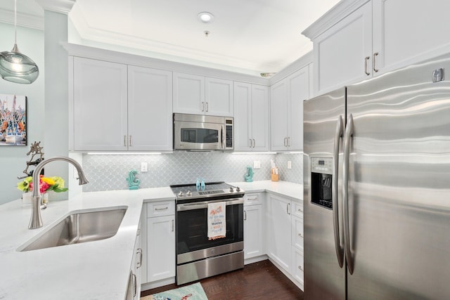 kitchen featuring crown molding, sink, appliances with stainless steel finishes, and white cabinetry