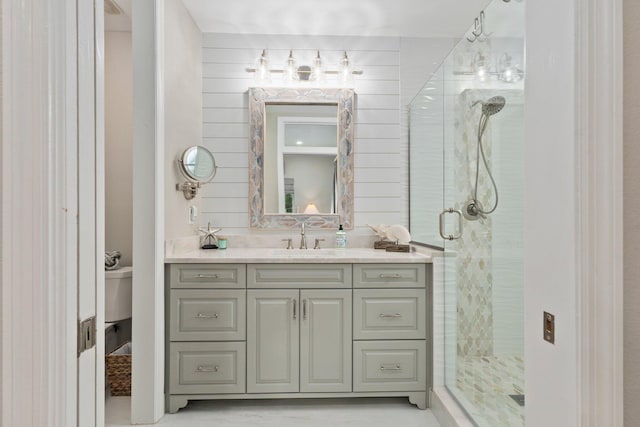 bathroom featuring wood walls, a shower with door, and vanity