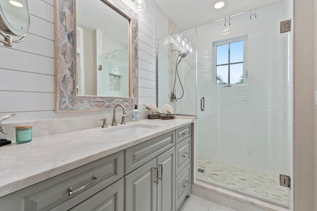 bathroom featuring an enclosed shower and vanity