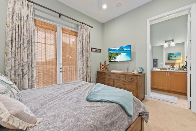 carpeted bedroom featuring connected bathroom and access to outside