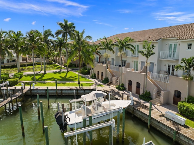 dock area with a balcony and a water view