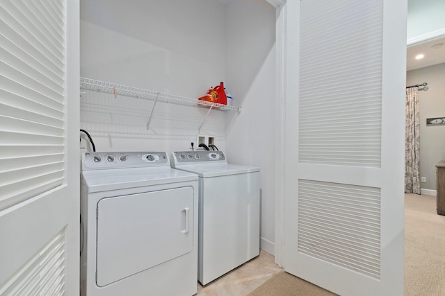 laundry room with light carpet and washing machine and dryer