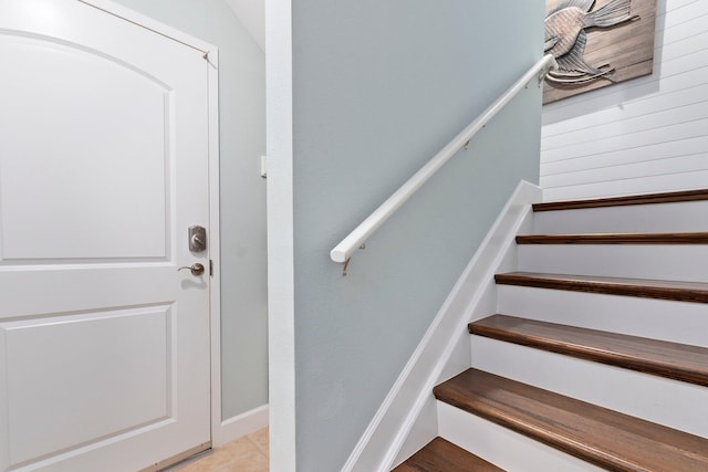 stairway with tile patterned floors