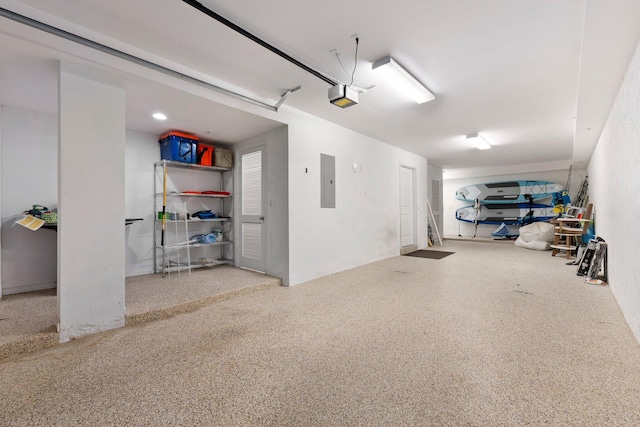 garage with electric panel and a garage door opener