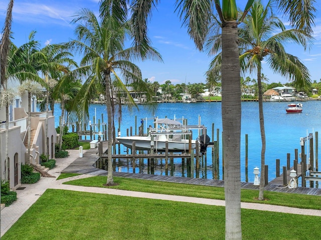 dock area with a water view and a lawn