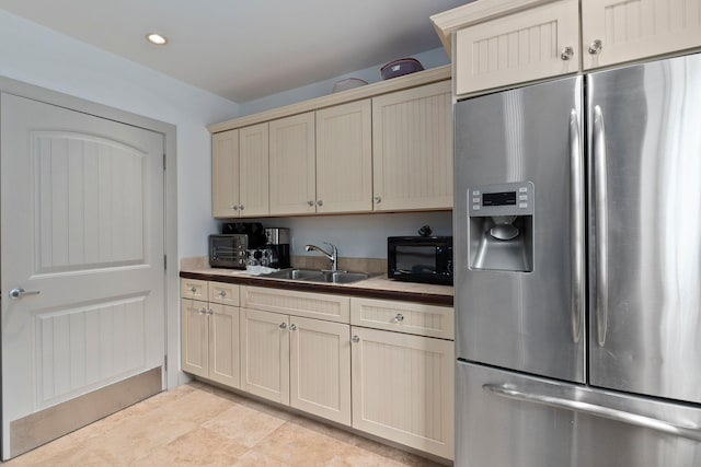 kitchen with stainless steel fridge and sink