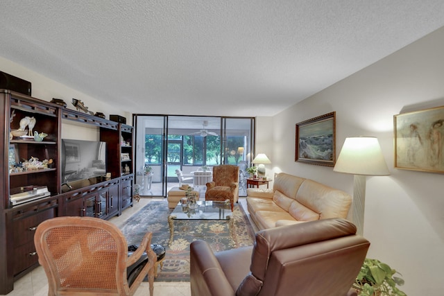 living room with light tile patterned floors, a textured ceiling, and floor to ceiling windows