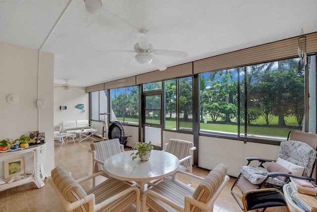 sunroom with ceiling fan and a healthy amount of sunlight