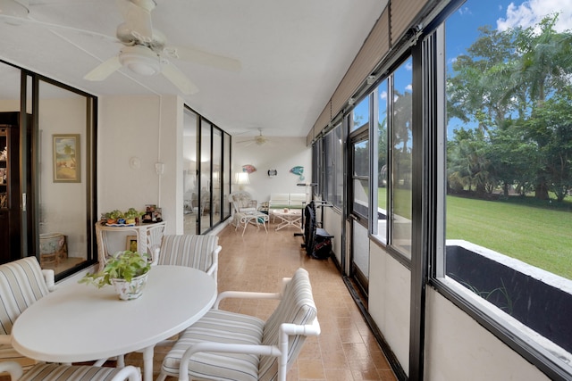 sunroom featuring ceiling fan and a healthy amount of sunlight