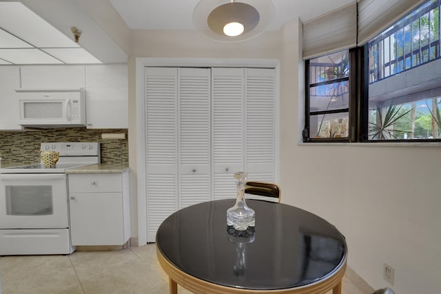 tiled dining space with a wealth of natural light