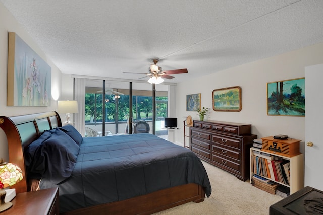 bedroom featuring ceiling fan, access to outside, light colored carpet, and a textured ceiling