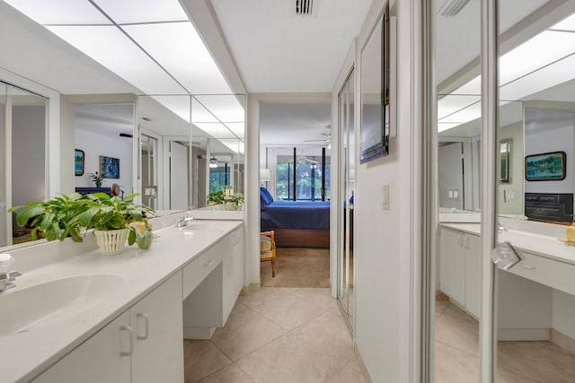 bathroom with ceiling fan, tile patterned floors, and vanity