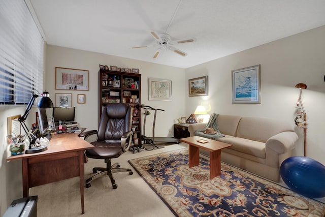 carpeted office space with ceiling fan