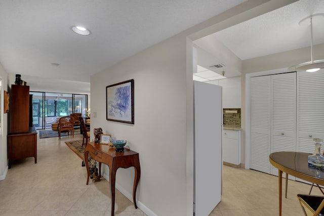 hallway with light tile patterned floors