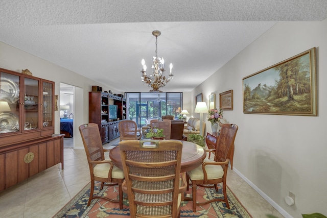 dining area featuring a textured ceiling, a chandelier, and light tile patterned floors