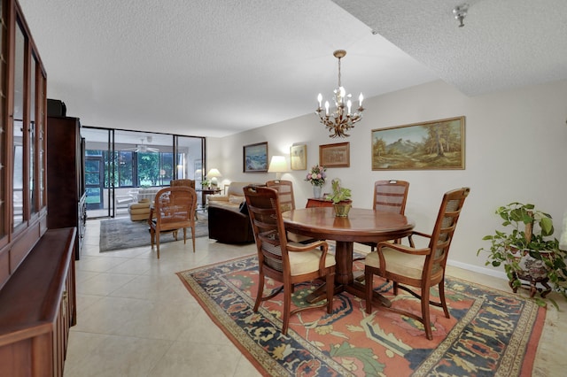 tiled dining area with a notable chandelier, a textured ceiling, and expansive windows