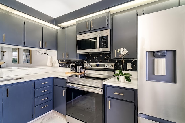 kitchen featuring blue cabinets, appliances with stainless steel finishes, tasteful backsplash, and light tile patterned floors