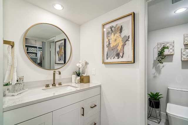 bathroom with vanity and toilet