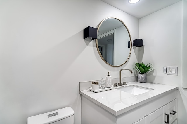 bathroom featuring vanity and toilet