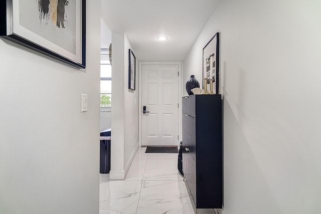 corridor featuring light tile patterned floors