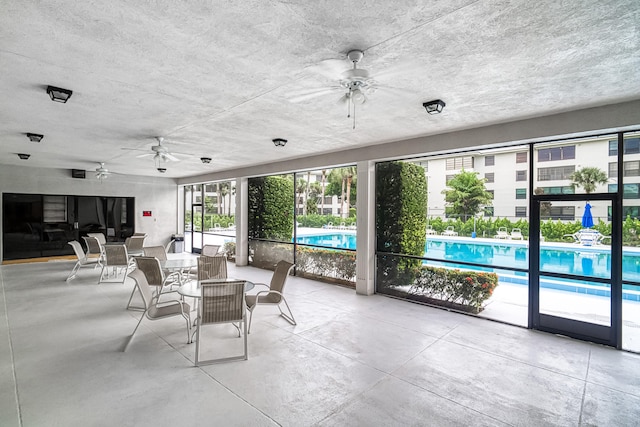 view of patio / terrace featuring a community pool and ceiling fan