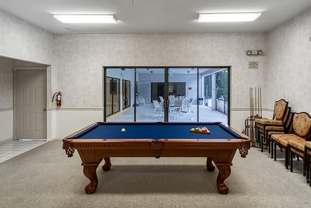 playroom featuring light colored carpet, pool table, and a textured ceiling