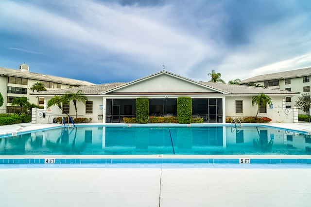 view of pool featuring a sunroom