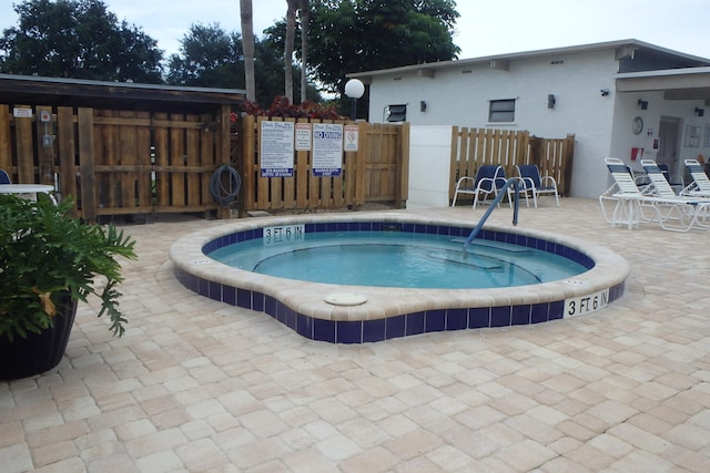 view of pool with a patio area and a community hot tub