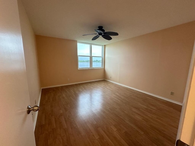 unfurnished room featuring ceiling fan and hardwood / wood-style floors