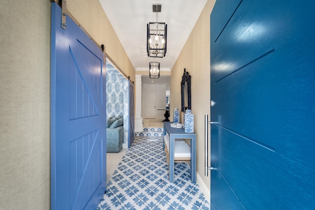 hallway with a barn door, crown molding, and a notable chandelier