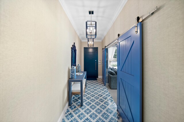 corridor featuring a barn door, baseboards, and ornamental molding