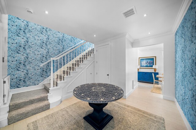 stairway featuring wood-type flooring and ornamental molding