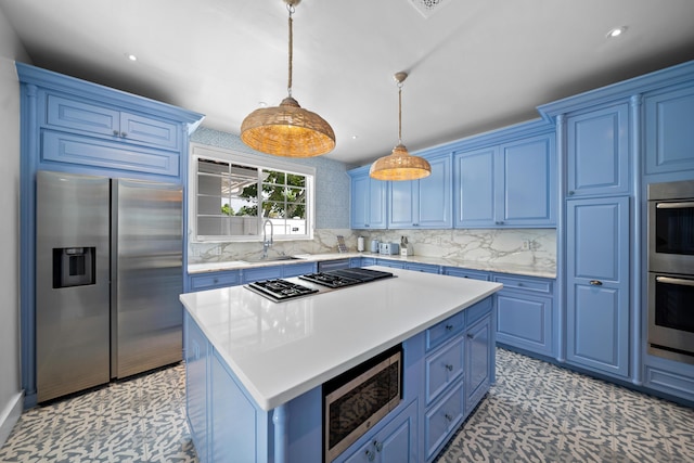 kitchen featuring blue cabinetry, a sink, tasteful backsplash, stainless steel appliances, and light countertops