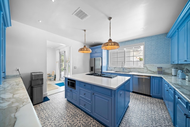 kitchen with blue cabinets, visible vents, a sink, a kitchen island, and stainless steel appliances