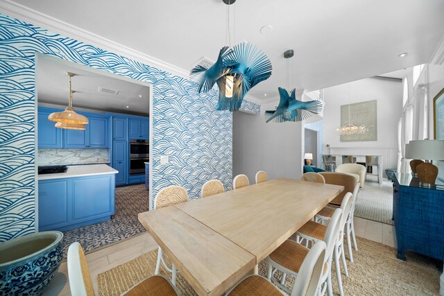 dining space with light tile patterned flooring and ornamental molding