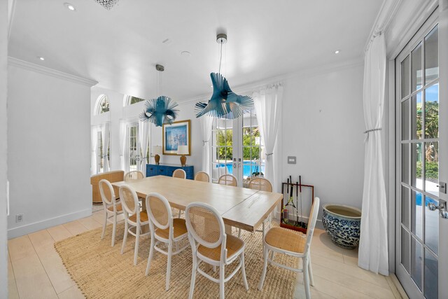 dining space featuring baseboards, ornamental molding, recessed lighting, light wood-style flooring, and french doors